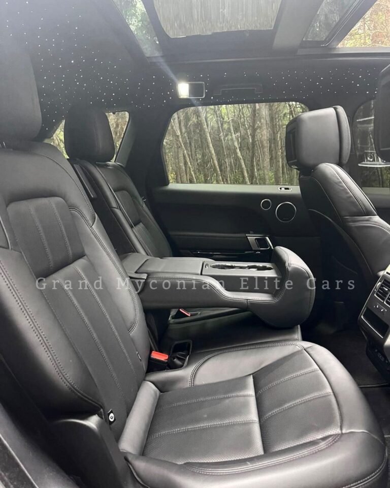 A vibrant sunset over a calm lake, with silhouetted trees framing the scene and colorful reflections on the waters surface.