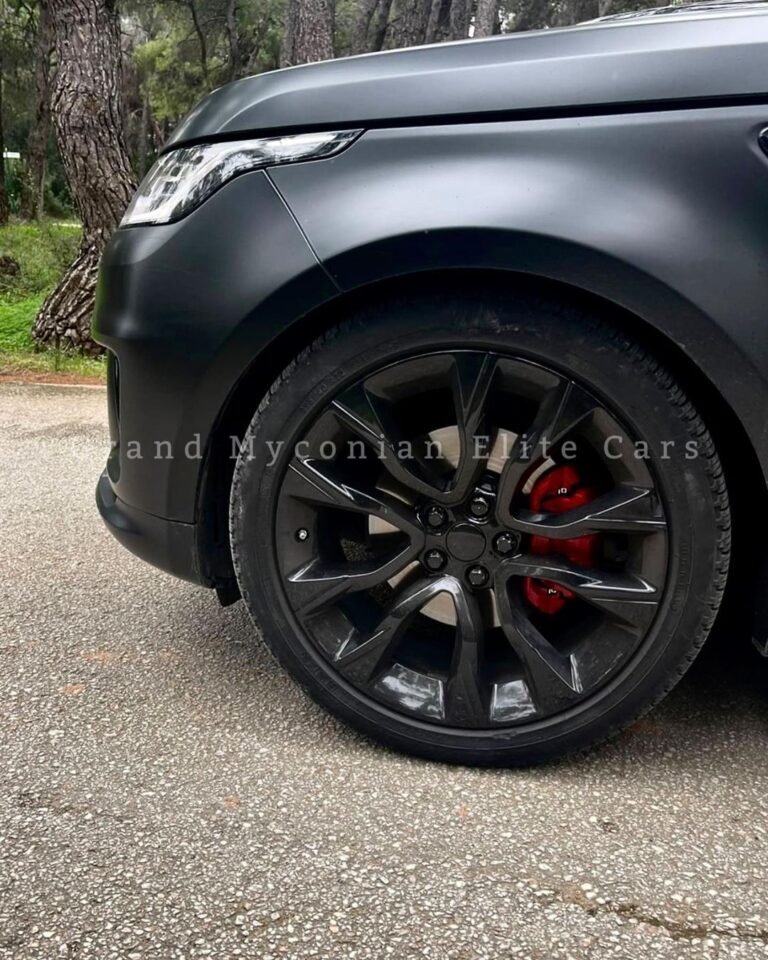A vibrant sunset over a tranquil lake, with silhouettes of trees and mountains in the background, reflecting colorful hues of orange, pink, and purple in the water.